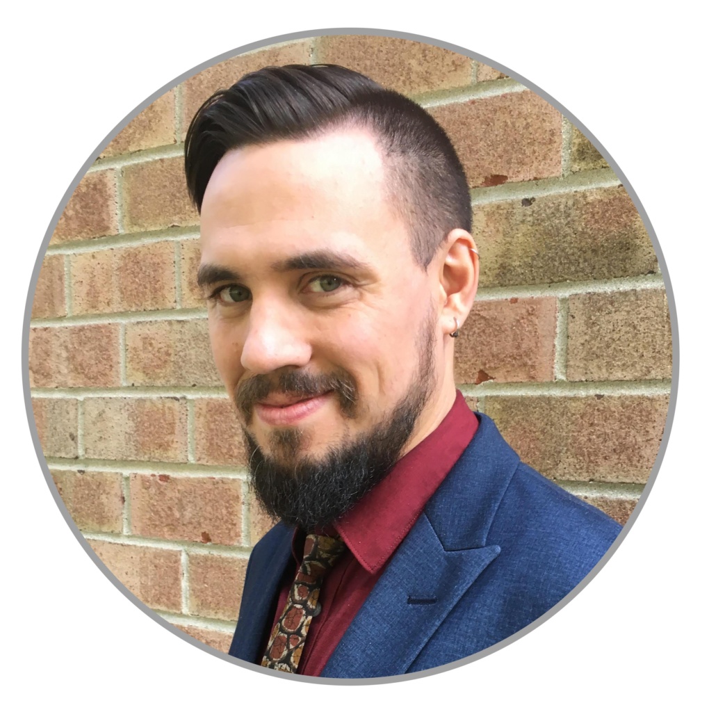 This is a headshot of David Woehr, Programming Manager. He has short brown hair and brown eyes. He is smiling.