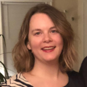 Photo of a woman with shoulder-length light brown hair.