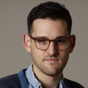 Photo of a man wearing glasses .