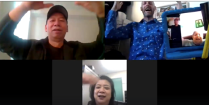 Photo of a clown class being led online. The participants and teaching artist are making funny faces.